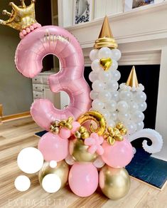 balloons are stacked on top of each other in the shape of numbers and princess crowns