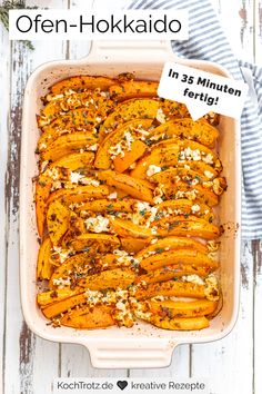 a casserole dish filled with baked sweet potatoes and topped with feta cheese