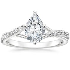 a white gold engagement ring with a pear shaped diamond in the center and side stones