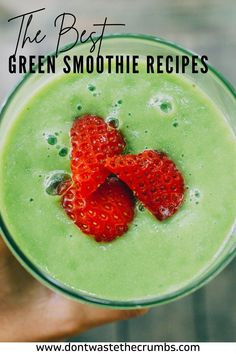 the best green smoothie recipe is in a glass with two strawberries on top