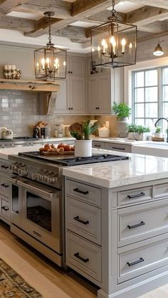 a large kitchen with an island in the middle and lots of lights hanging from the ceiling