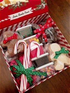 a box filled with assorted candy and candies on top of a wooden table