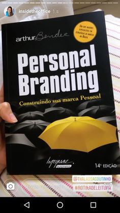 a person holding up a book with an umbrella on it's cover in spanish