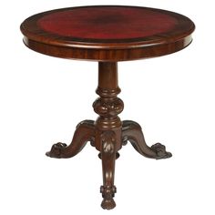 an antique wooden table with red paint on it