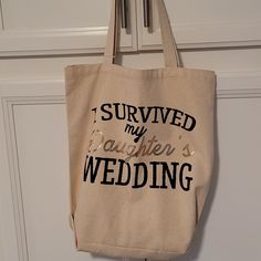 a tote bag that says i survived my daughter's wedding hanging on the door