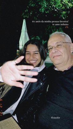 an older man and young woman posing for a photo