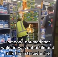 two men in yellow vests and safety vests are looking into a refrigerator filled with water