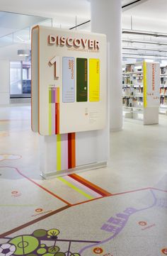 the interior of a library with bookshelves and colorful graphics on the flooring