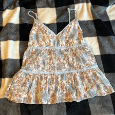 American Eagle Outfitters Tank Top Blouse. Size Xs. Beautiful Flowery Design, Has Great Movement. Very Pretty! Basically New Without Tags. Spring Brown Camisole, Brown Spring Camisole, Brown Spaghetti Strap Top For Summer, Brown Spaghetti Strap Tops For Spring, Spring Brown Spaghetti Strap Tops, Brown Tops With Adjustable Straps For Summer, Summer Brown Tops With Floral Print, Brown Casual Camisole With Spaghetti Straps, Brown V-neck Camisole For Summer