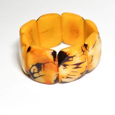 This beautiful organic Tagua Nut Mustard Yellow Chunky Statement Bracelet is a combination of luxury and elegance at its best.   If you desire the luxury of ivory, think of Ecuador's rain forests, where ivory is so abundant that it grows on trees! Make a statement without saying a word!  SIZE This Tagua Bracelet is connected with two strands of elastic. Each Tagua piece is approximately 1.25" in length. The bracelet measures 7" in circumference (inner).  RECOMMENDED NECKLACE https://www.etsy.com Elegant Yellow Bangle Bracelet, Elegant Yellow Bangle Bracelets, Elegant Yellow Bracelet As Gift, Elegant Yellow Bracelet As A Gift, Yellow Bangle Bracelets For Formal Occasion, Elegant Adjustable Yellow Bangle, Elegant Rectangular Cuff Bracelet, Elegant Yellow Cuff Bracelet As Gift, Elegant Yellow Cuff Bracelet Gift