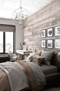 a bedroom with wood paneling and pictures on the wall above the bed, along with a leather couch