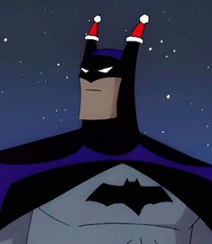 batman with santa hats on his head standing in front of the stars and moon sky