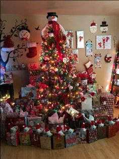 a decorated christmas tree with presents under it