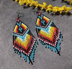 These native American fringe beaded earrings are made from high quality Delica seed beads so they are a fairly lightweight earring. I love that the fire colors make a heart on the fringe! 100% handmade with passion and attention to detail. Each piece can take hours to complete. Great to wear for any occasion and would be a nice addition to your wardrobe. They would also make a great gift! Please check out the many other listings in my shop! https://barbsbeadingstudio.etsy.com I've made every eff Orange Beaded Earrings Native American, Native Beaded Earrings Feather, Cherokee Beaded Earrings, Native American Beaded Earrings Inspire Uplift ⭐, Fringe Beaded Earrings, Southwestern Multicolor Nickel-free Beaded Earrings, Beaded Fringe Earrings, Handmade Gifts For Her, Southwest Style