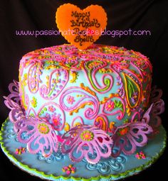 a colorful cake decorated with swirls and hearts