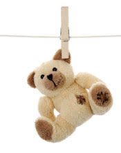 a teddy bear hanging on a clothes line