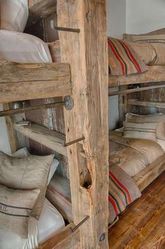 the bunk beds are made out of wood and have pillows on them, along with other items