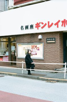 a woman standing in front of a store