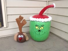 an inflatable christmas cup with reindeer nose and nose on the ground next to it