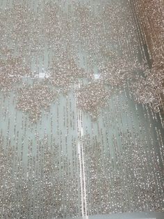 the floor is covered in silver sequins and has been placed on top of it