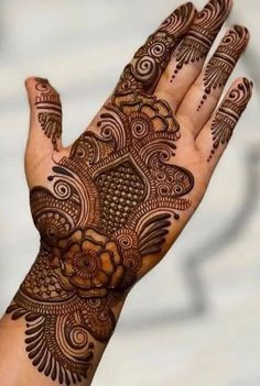 the hand is decorated with henna designs