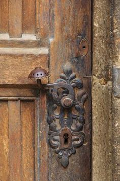 an old wooden door with a metal handle