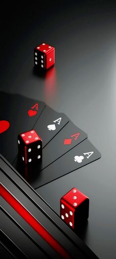 red dices and black cards on a dark surface