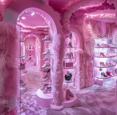 a pink room filled with lots of shoes and fur covered walls in the middle of it