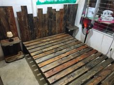 a bed made out of wooden pallets in a room