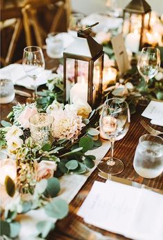 the table is set with flowers and candles