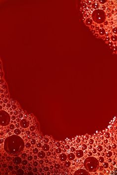 an abstract red background with lots of bubbles