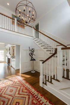 a staircase in a home with white walls and wood floors