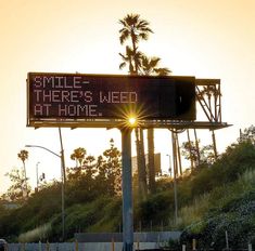 a sign that says smile there's not home on the side of a road