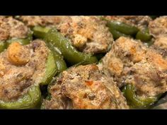 green peppers covered in meat and seasoning sitting on a plate with other food items