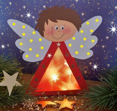 a paper angel is sitting on top of a christmas tree with its lights turned on