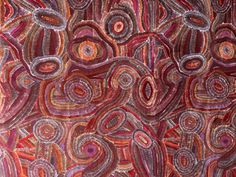 an abstract painting with circles and lines on it's surface in red, orange, purple