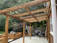 an outdoor area with wooden structures and lots of woodwork on the outside, including a pergolated roof