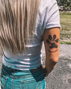 a woman with a dog paw tattoo on her arm