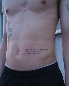 a shirtless man with tattoos on his chest and the words'the voice of reason breaks with a quiet tongue '