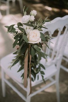 a bouquet of flowers sitting on top of a white chair