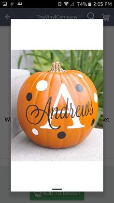 an orange pumpkin with black polka dots and the letter a painted on it's side