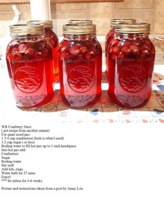 three jars filled with red liquid sitting on top of a table