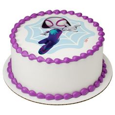 a white cake with purple frosting and an image of a cartoon character on it