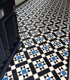 a black and white tiled floor with blue accents