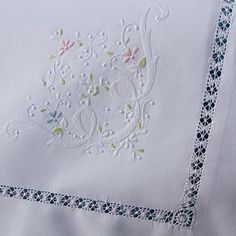 a close up of a piece of cloth with embroidered designs on it