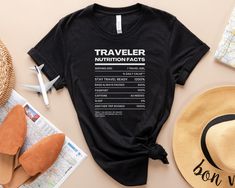 "Embark on your adventures with confidence and style wearing our innovative \"Traveler Nutrition Facts\" Travel Shirt. Designed for the modern explorer, this shirt is more than just apparel; it's a statement of your wanderlust spirit and a nod to the essential elements of every traveler's journey.   This Tee is UNISEX. Please size down for a form-fitting style. This unisex essential fits like a well-loved favorite tee, featuring a crew neck, and short sleeves, and is designed with superior Airlume combed and ring-spun cotton. Sideseamed. Unisex sizing. Shoulder taping. Wash apparel inside out. Dry on low heat." Black Crew Neck T-shirt For Travel, Casual Graphic Print Travel Shirt, Casual Black Top For Travel, Graphic Tee With Crew Neck For Travel, Graphic Tee With Letter Print For Travel, Vacation Tshirts, Travel Tshirt, Tshirt For Women, Travel Shirt