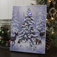 a christmas tree with deer and birds painted on it