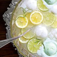 a bowl filled with lemons and lime slices