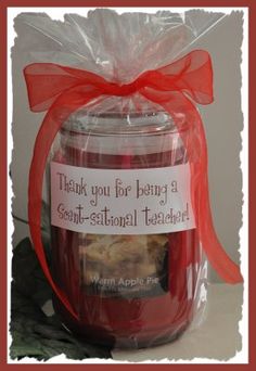 an apple pie in a glass jar with a red ribbon tied around it and thank you for being a great - national teacher