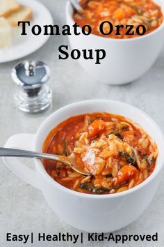 two bowls of tomato orzo soup with bread on the side